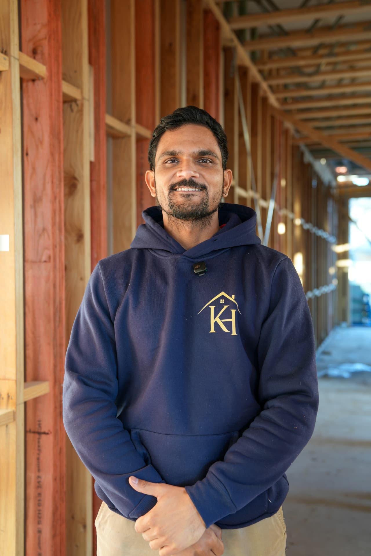 Builder on site in front of timber framing