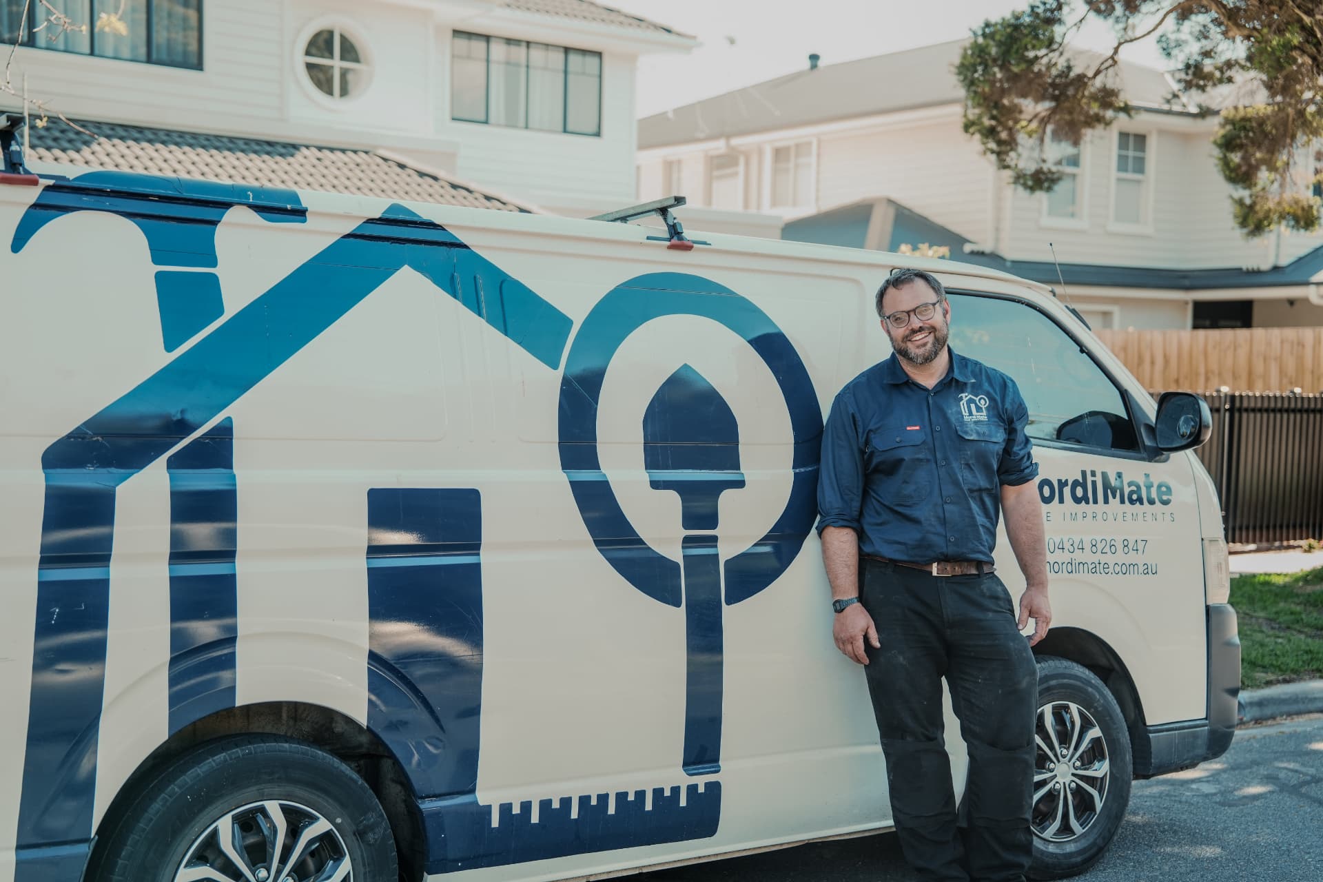 Home improvement tradesman beside branded van